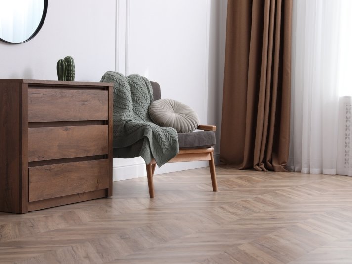 Neutral brown flooring in a herringbone pattern with modern furniture